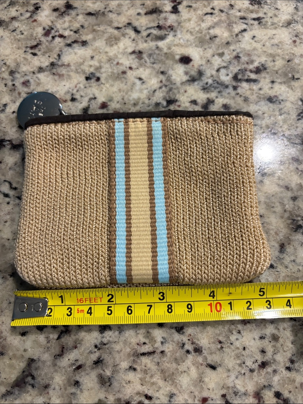 The Sak Coin Purse with Sak medallion. Beige with beige and baby blue stripes.